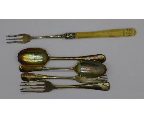A silver pickle fork, two other silver forks and two silver spoons, 110g