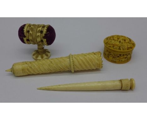 A carved ivory pill box, two needle cases and a pin cushion