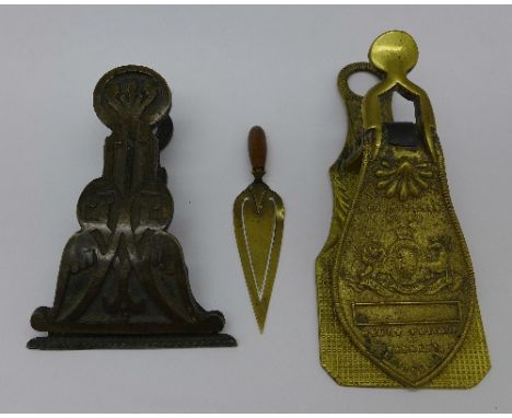 Two paper clips, one marked Merry Phipson & Parker's Letter Clip, and a miniature page marker in the form of a trowel