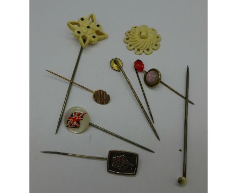 Eight stick pins including two carved bone