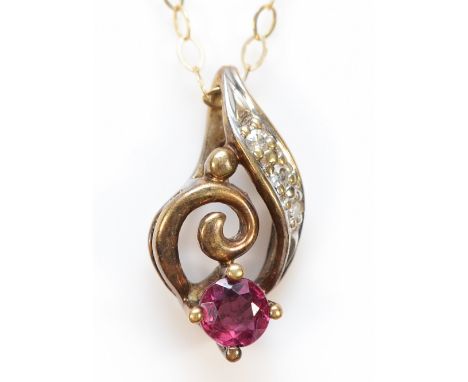 A 9ct gold diamond and ruby twist pendant on a chain, 1g