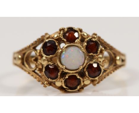 A 9ct gold opal and garnet floral cluster ring, with open work shoulders, Q, 2.7g