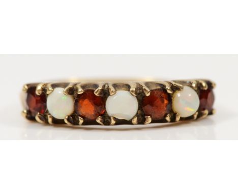 A 9ct gold garnet and opal dress ring, central opal chipped, L, 2g