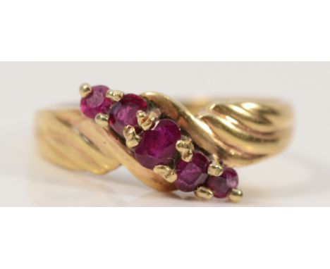 A 14K gold ruby five stone cross over ring, L, 2.8g