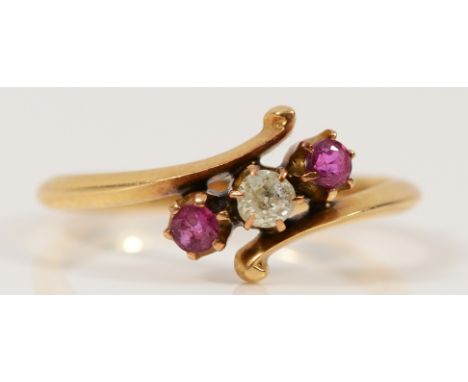 An 18ct gold ruby and diamond three stone cross over ring, N, 2.3g