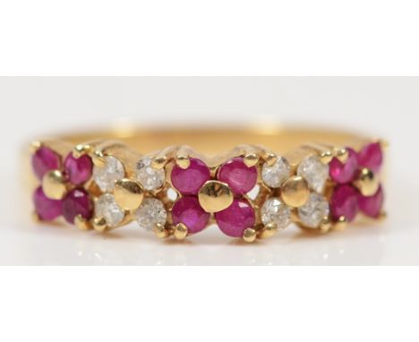 A 9ct gold ruby and brilliant cut diamond floral half eternity ring, M, 1.8g