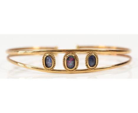 A 9ct gold opal triplet bangle, 60mm, 5.2g