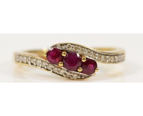 A 9ct gold ruby and diamond cross over ring, P, 2.5g