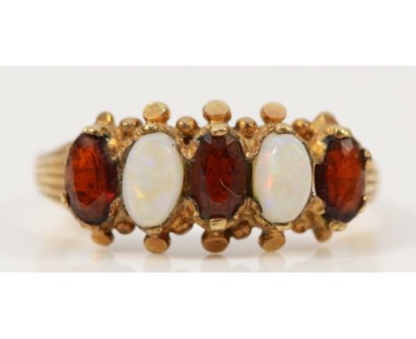 A 9ct gold garnet and opal five stone ring, L 1/2, 2.1g