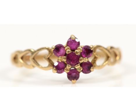 A 9ct gold ruby cluster dress ring with heart open work to the shoulders, O 1/2, 1.3g