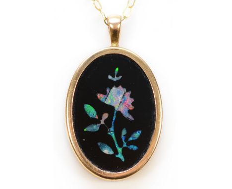 A 9ct gold onyx with opal inlay floral pendant with a chain, 18mm x 12mm, 1.5g
