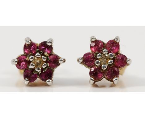 A pair of 9ct gold ruby and diamond floral cluster earrings with scroll backs, 1.3g
