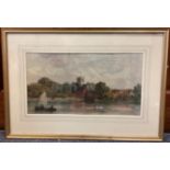 A framed and glazed watercolour depicting a river scene with boat and swans by a village.