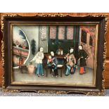 CHINESE SCHOOL: A gilt framed reverse painted oil on glass depicting Oriental figures.