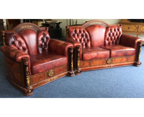 A massive 20th Century leather button back settee and matching armchair. Est. £50 - £80.