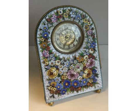 A micro mosaic desk clock with floral decoration and winged infant to dial. Pen marked 'Boscowan E/R' to reverse. Approx. 19 