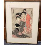 A framed and glazed woodblock print depicting Japanese ladies.