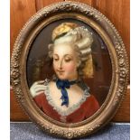 An oval gilt framed and glazed oil on glass reverse portrait of a lady with parrot.