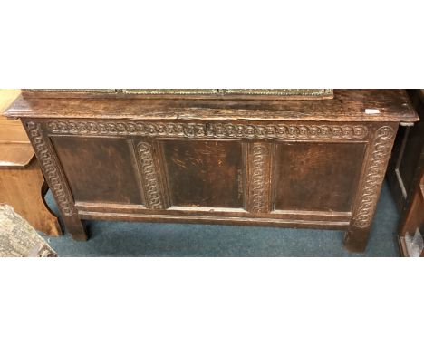A Georgian oak three-panel coffer with carved decoration. Est. £80 - £120.