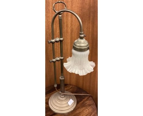 An unusual brass lamp with shaped glass shade. Est. £50 - £80.