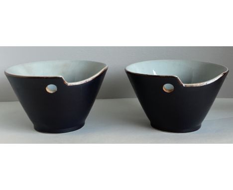 A pair of stylish pottery ramen / rice bowls with blue glazed interior to matt black glazed exterior and chopstick holes. App