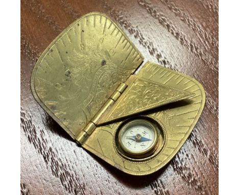 An unusual Antique brass folding compass with engraved decoration. Est. £80 - £120.