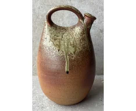 JOHN LEACH: (British, 1939 - 2021): A stoneware pottery 'Pilgrim' flask / flagon with handle to top of drip glaze design. Imp