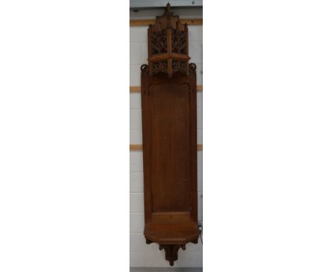 An early 20th century church shrine for housing a religious sacred figure with carved pierced canopy over a pentagonal shelf,