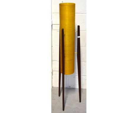 A retro rocket lamp with yellow shade, raised on three tapering wooden supports, height 113cm.