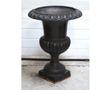 A cast iron garden planter in the form of an urn on a pedestal base, height 80cm.