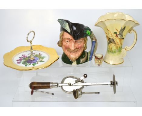 A vintage 'Veedee' vibrating massage machine for gout and rheumatism, a Royal Doulton character jug D6527 'Robin Hood', a cak