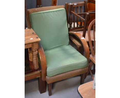 An Art Deco armchair with curving arms to tapering supports, two oak dining chairs and a Windsor style painted kitchen chair 