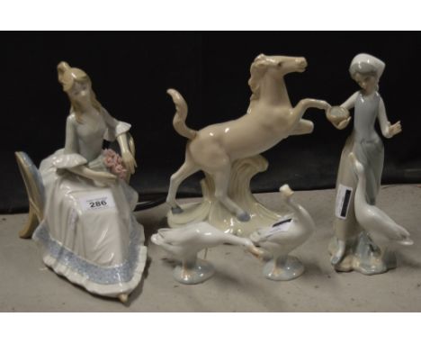 A Lladró figural group depicting a girl with a basket of seed and a goose (af), two individual Lladró geese and two Lladró st