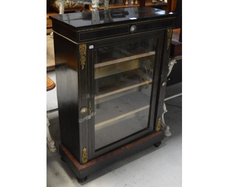 An early Victorian ebonised and inlaid pier cabinet with a single glazed door, with ormolu mounts and ceramic inserts, approx