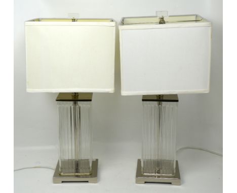 A pair of contemporary table lamps, fluted square glass body on chromed base with matching white silk square light shades, he