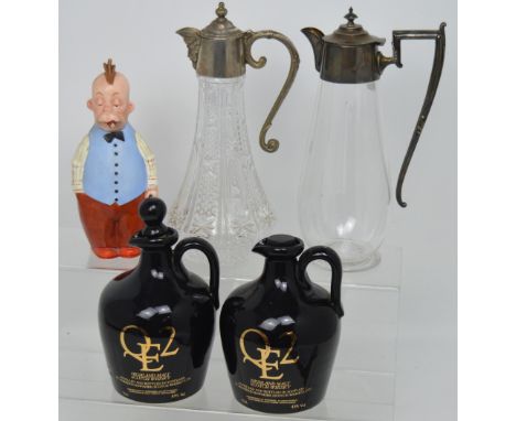 A collection of decanters and claret jugs to include two glass claret jugs, silver plated mounts with incorporated handles, t