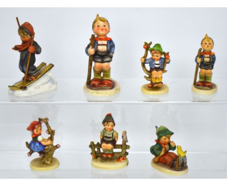 Seven Hummel figures; 'Little Hiker' (af), 'Apple Girl' (af), small boy sitting in an apple tree, a young boy skiing signed t