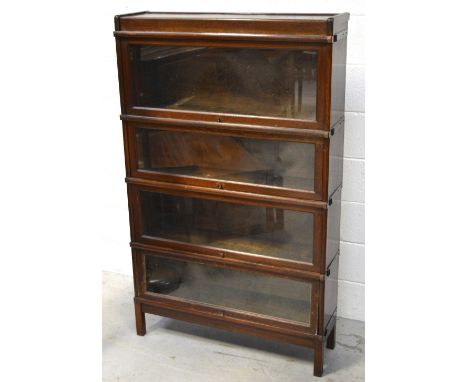 An oak Globe-Wernicke style four-section bookcase on square supports, height 142cm.