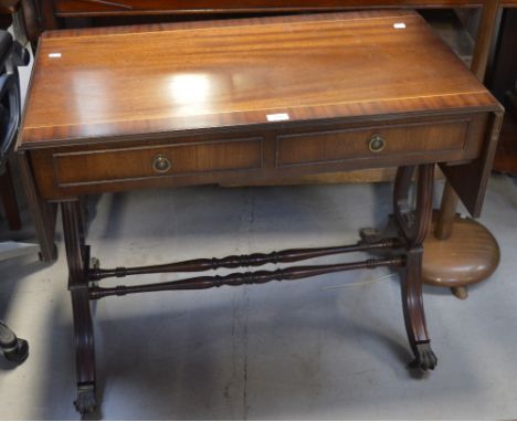 A reproduction inlaid sofa table on lyre supports and cross stretcher.