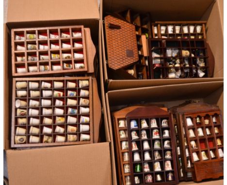 A good quantity of largely ceramic thimbles, all contained within wooden display cases.