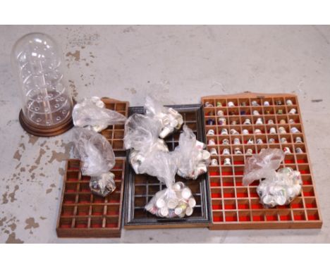 A quantity of ceramic thimbles and five various display cases/stands.