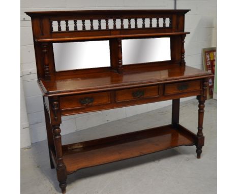 A Victorian mahogany mirror back sideboard with turned top rail over three drawers, shelf below, on turned supports with peg 