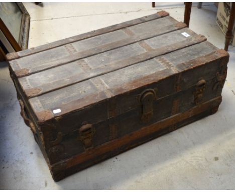A strap bound travelling trunk with twin leather handles and lock inscribed 'Eagle Lock Co. Terryville, USA', width 82cm.