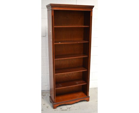 A reproduction mahogany six shelf bookcase with carved Grecian key decoration to pediment on bracket feet, height 180cm, widt