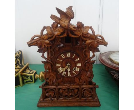 An oak Black Forest style mantel cuckoo clock and wall bracket