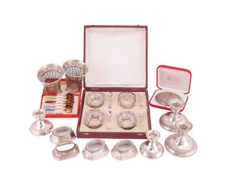 A pair of continental white metal pierced baskets stamped 833, a pair of silver dwarf candlesticks with weighted bases, a pai