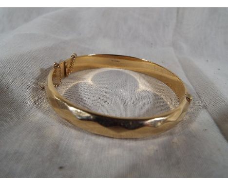 A lady's English hallmarked 9ct gold torque bangle, approximate weight 10.4 grams - Est £80 - £120