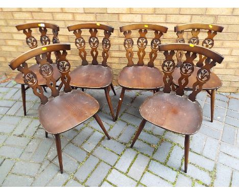 Six Ercol dining chairs decorated in the Fleur de Lis pattern