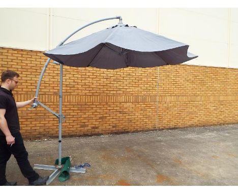 A large patio parasol on adjustable stand