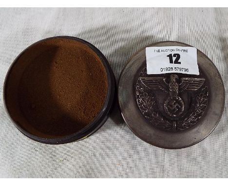A snuff box with screw release lid bearing eagle and the Third Reich symbol